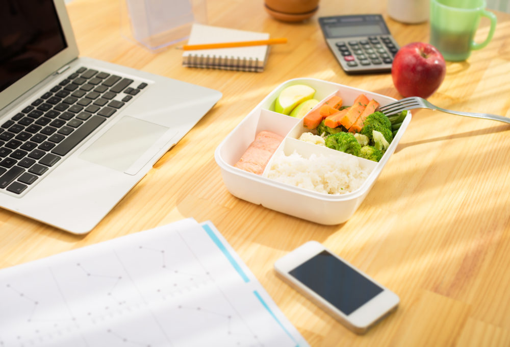 Office desk, computer and waste free lunch